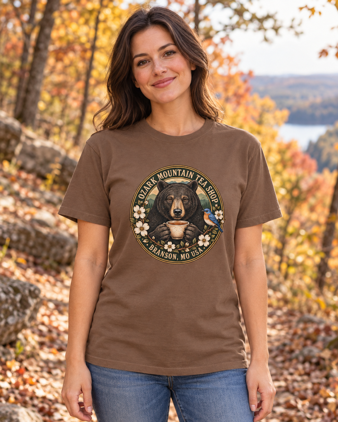 AI-generated woman modeling Ozark Tea Bear — Garment-Dyed T-Shirt in an autumn Ozark setting