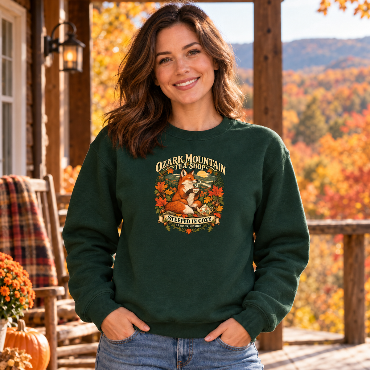 AI-generated lifestyle mockup of a woman wearing the forest-green Steeped in Cozy fox sweatshirt on a rustic autumn porch.